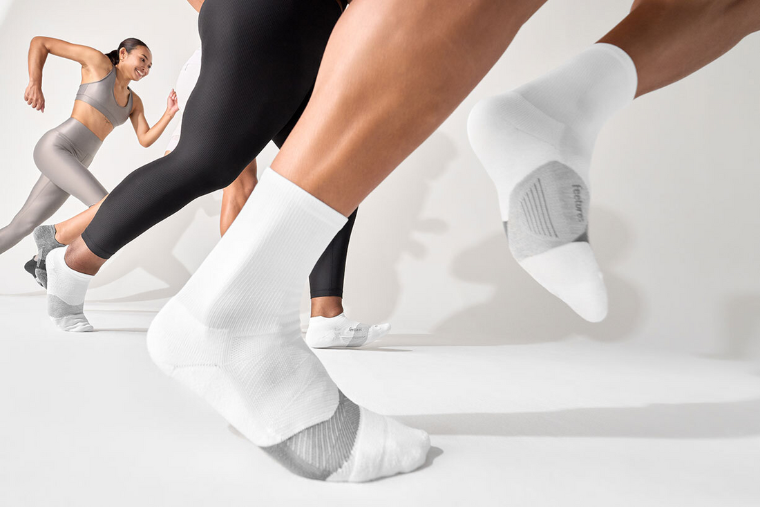 Women running in pairs of Feetures crew socks